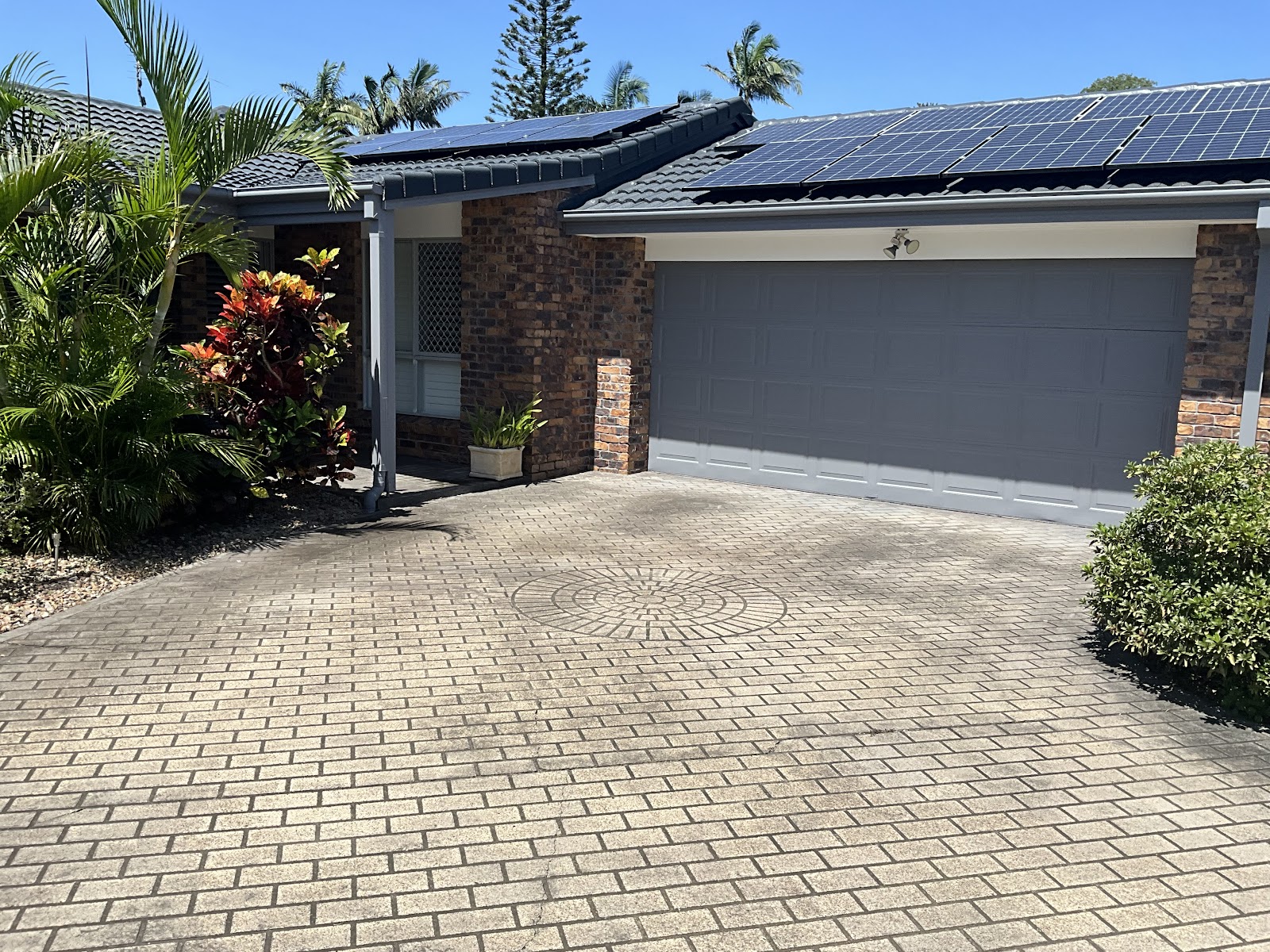 Brick home with a freshly painted grey garage door